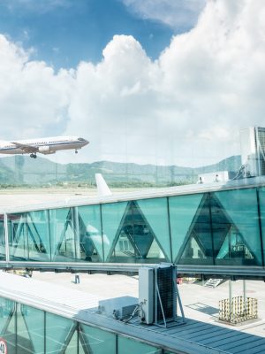 view out of airport windows, take off the flight with  sunny sky