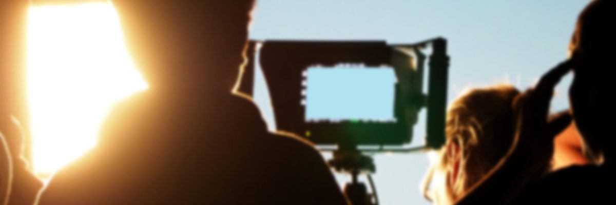 Blurry images of silhouette people film crew team working behind the scenes for shooting video production with professional equipment camera and lighting in the studio.