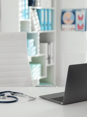 Doctor's workplace with modern laptop in office