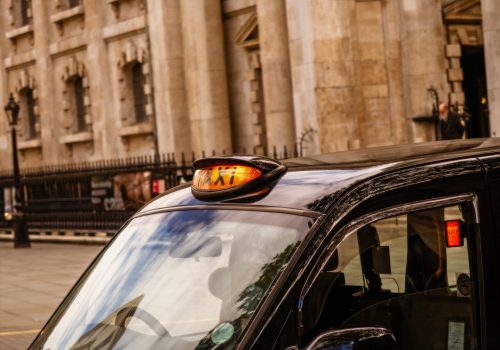 A view of London black cab taxi for hire around Trafalgar square
