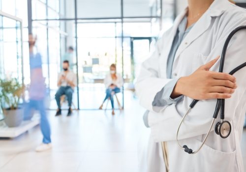 Medical healthcare doctor, woman worker or employee arms crossed confident with stethoscope in busy.