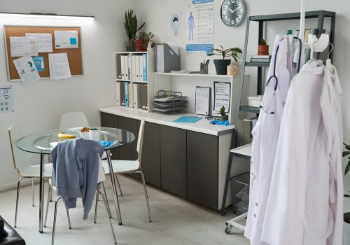 Medical office featuring organized workspace setup with documents and medical equipment. Well-maintained office with a clear focus on professional environment and functionality