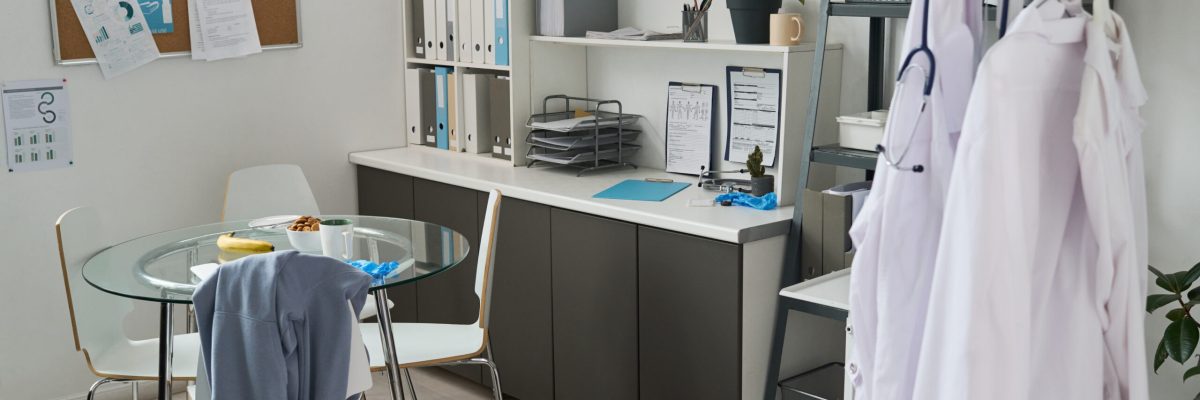 Medical office featuring organized workspace setup with documents and medical equipment. Well-maintained office with a clear focus on professional environment and functionality