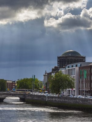 Storm clouds and sunrays over the River Liffey and the city of Dublin in the Republic of Ireland.