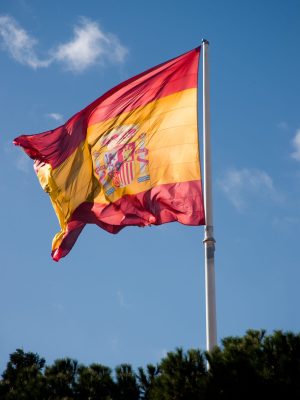 spain-flag-waving-on-blue-sky-2025-10-17-02-32-48-utc-scaled.jpg