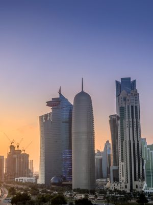 The skyscrapers in the skyline of the commercial center of Doha, the capital of the Arabian Gulf country Qatar at sunset.