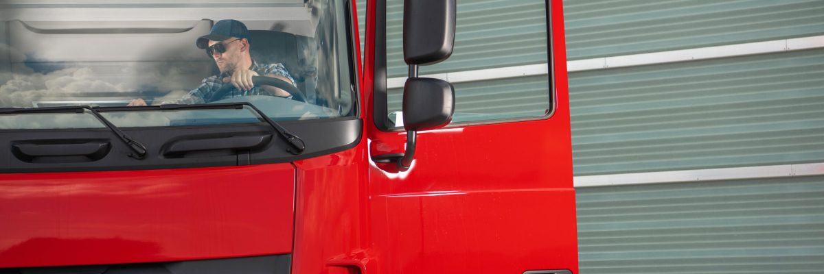 Transportation Industry Theme. Caucasian Professional Trucker in His 40s Inside His Truck Cabin Preparing For a Route