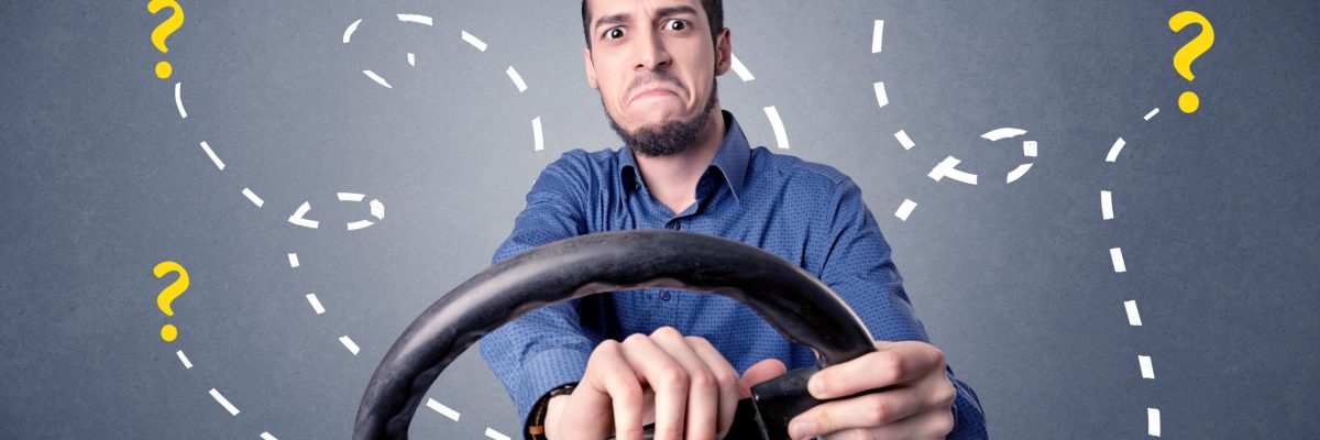 young-man-holding-black-steering-wheel-with-questi-2025-10-13-13-33-31-utc